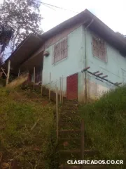 Vendo lote con casa de madera en quebradas de rio azul (1 km e del liceo de san antonio)